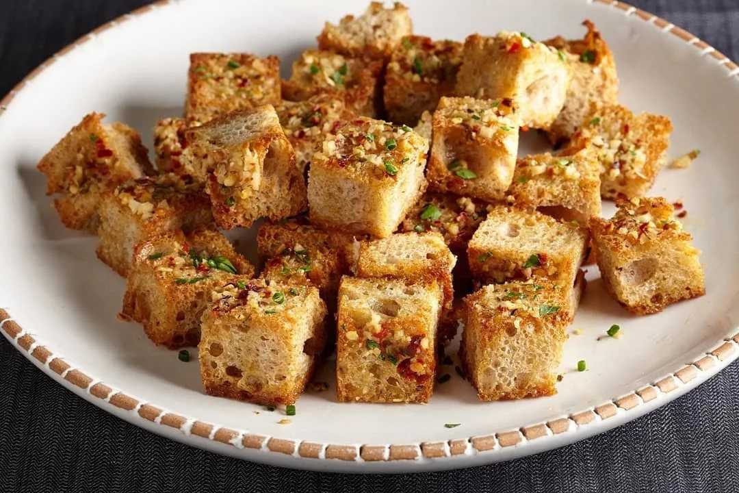 Гренки из белого хлеба в духовке — очень вкусная и ароматная закуска, приготовить которую сможет даже начинающий кулинар Наш рецепт поможет в этом